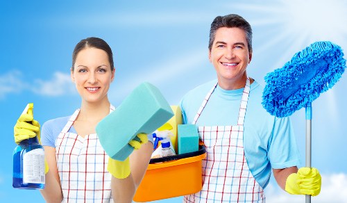 Professional carpet cleaner working carefully with insured safety procedures